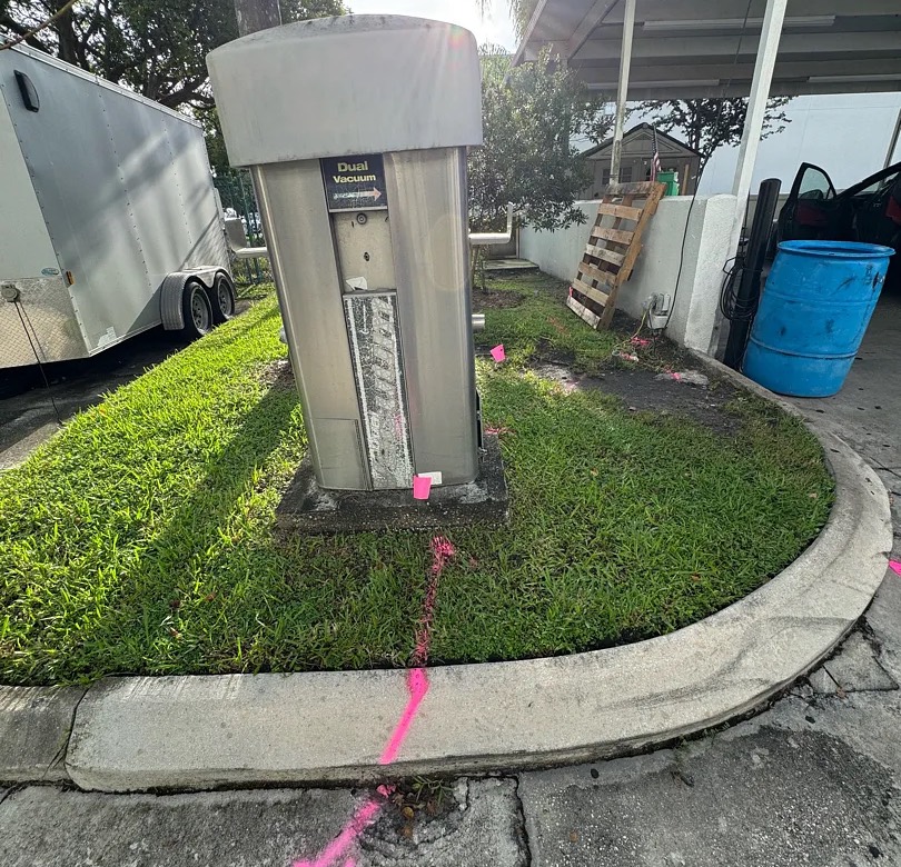 Electric service traced from a pedestal and marked across a curb on a commercial property in South Florida