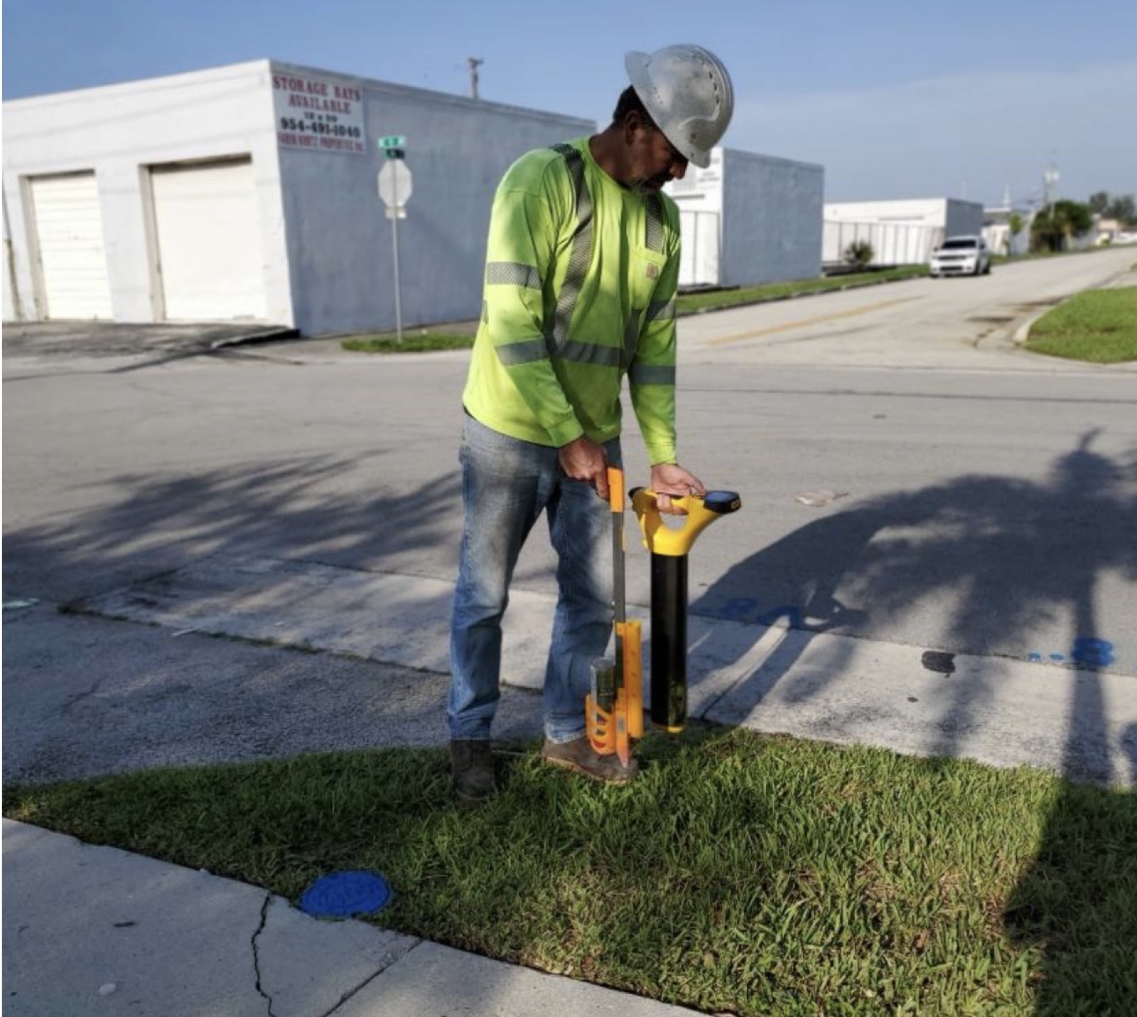 Technician performing electromagnetic private utility locating on a South Florida job site